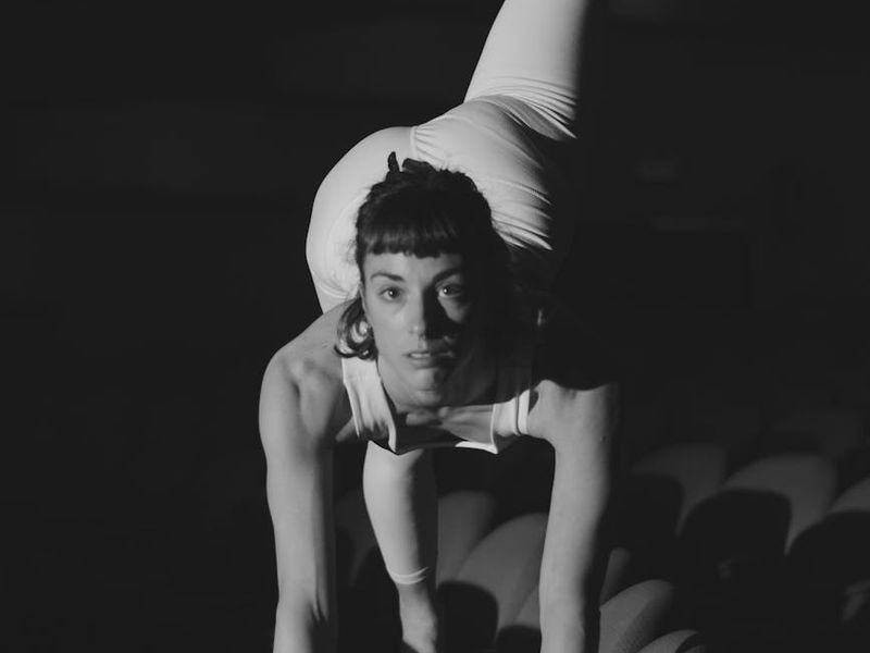 Woman performing a precise balancing exercise.